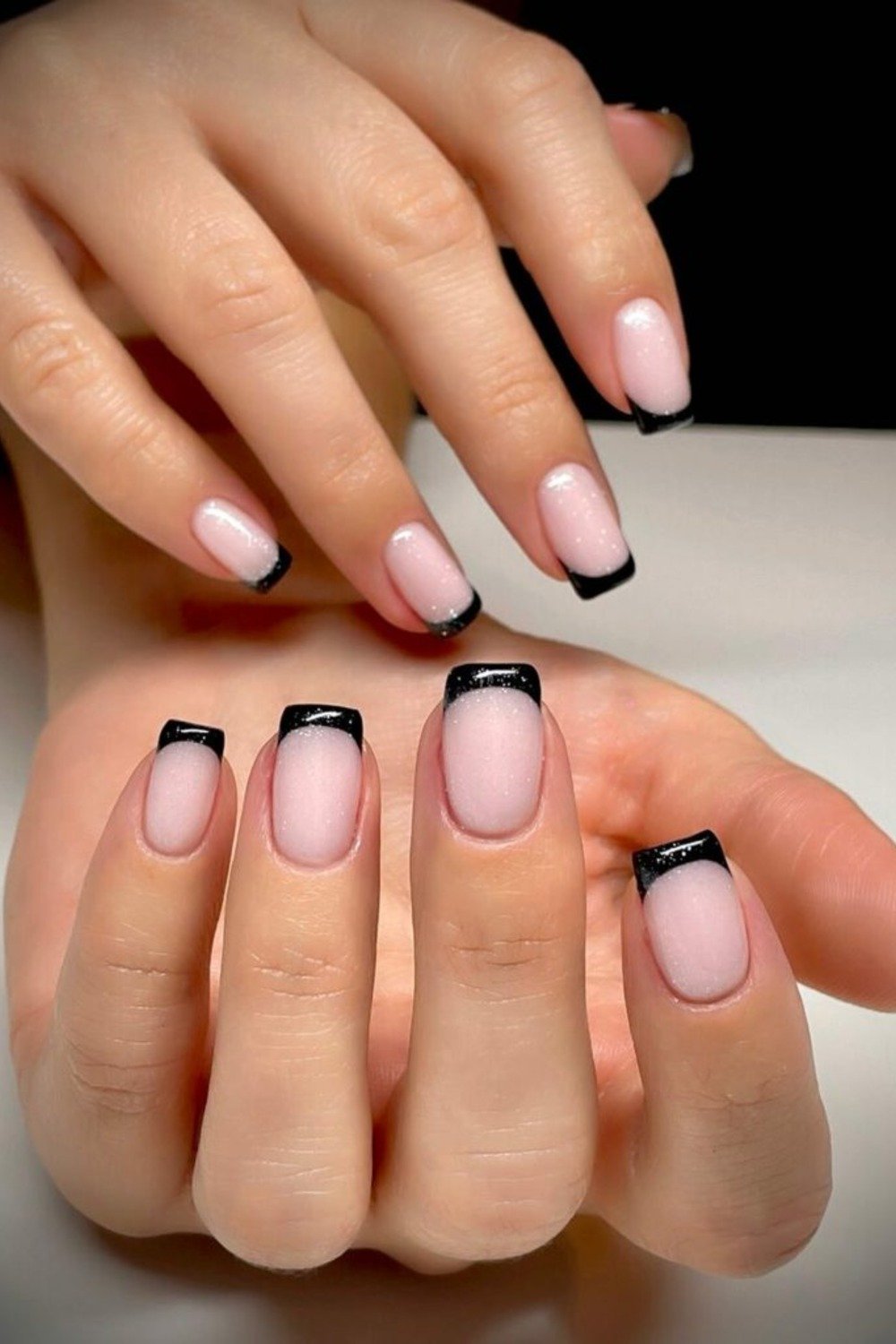 19. Black French Tips on Shimmery Nude