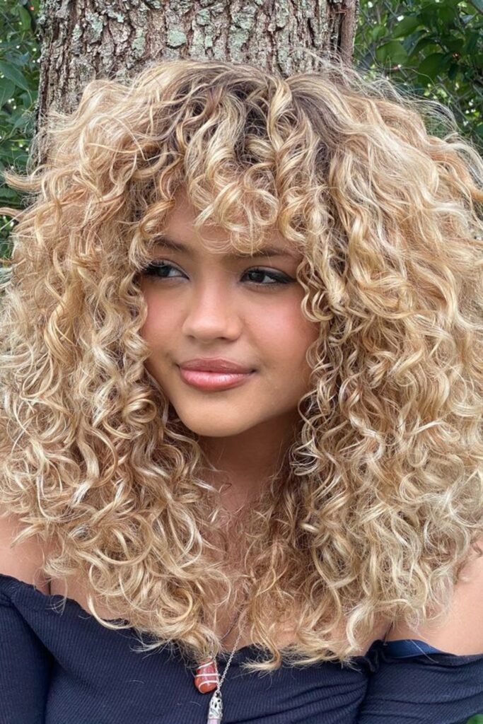 7. (Honey Blonde Spiral Curls with Curly Bangs)