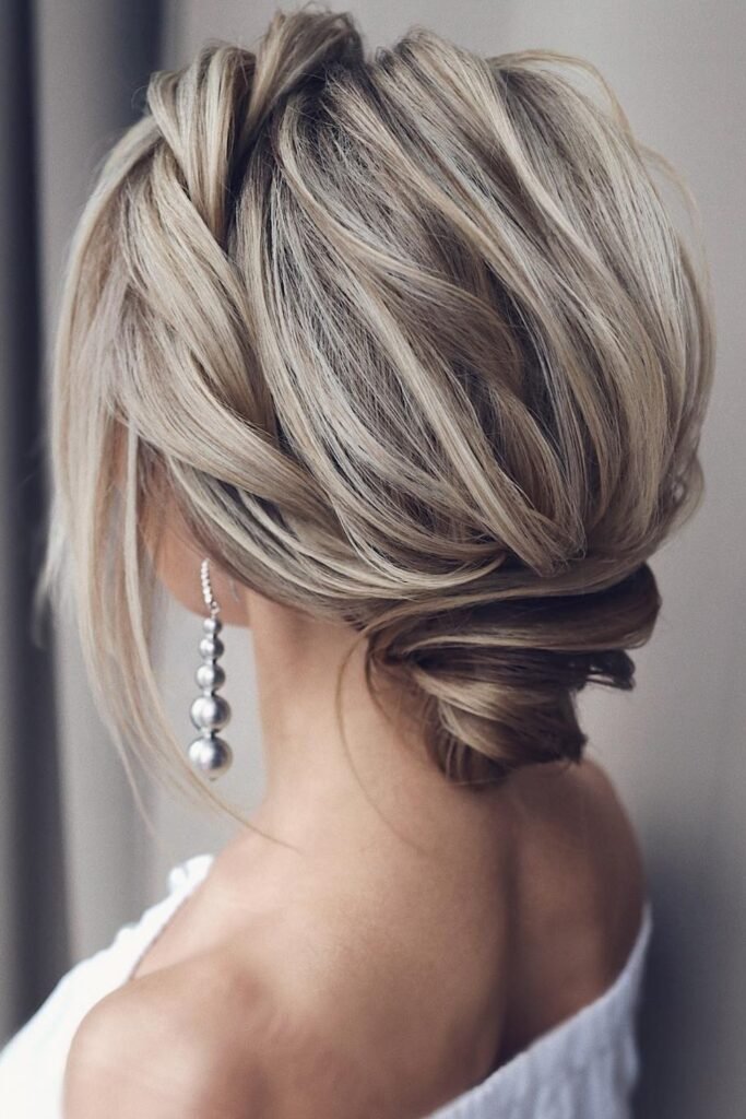 16. (Textured Low Updo with Face Framing Strands)