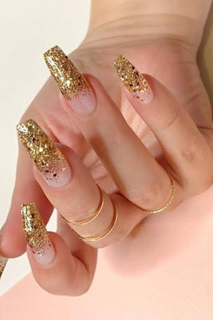 10. Gold Glitter Ombre Coffin Nails