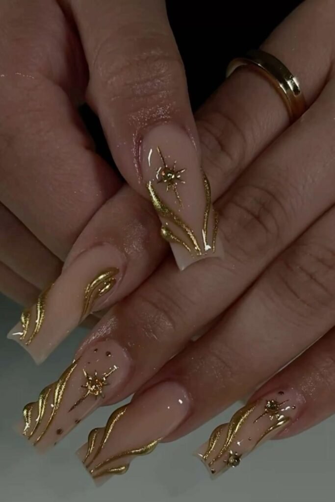15. 3D Gold Swirl Coffin Nails with Starbursts