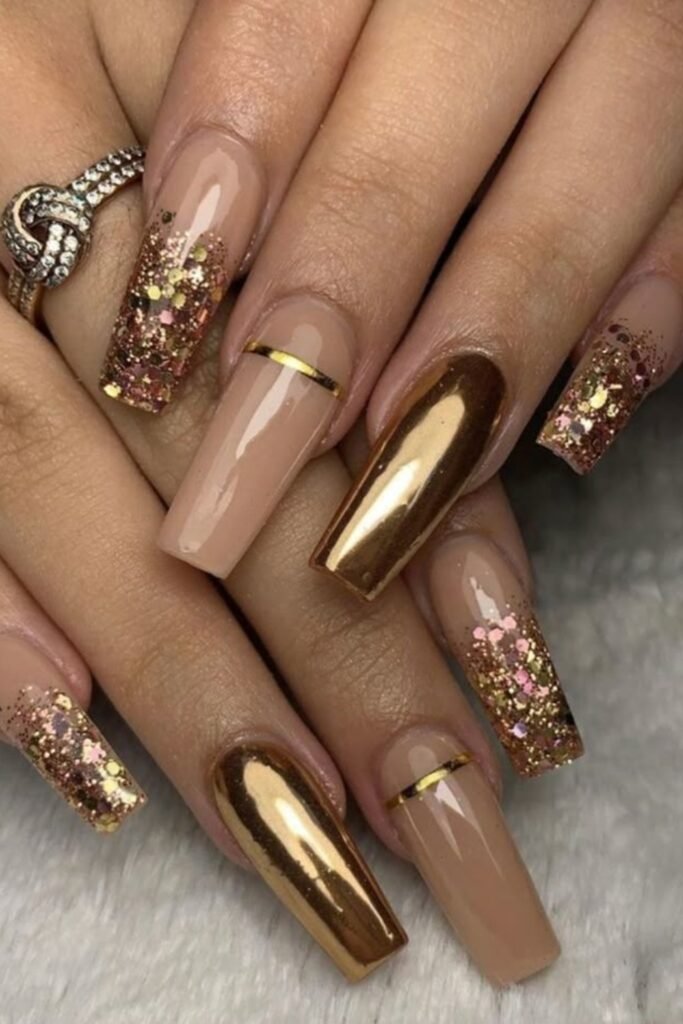 19. Nude, Gold Chrome, and Glitter Mix Coffin Nails