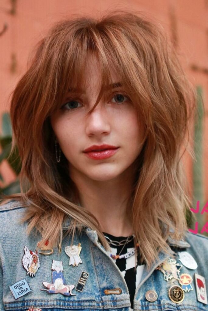 10. Strawberry Blonde Shag with Curtain Bangs