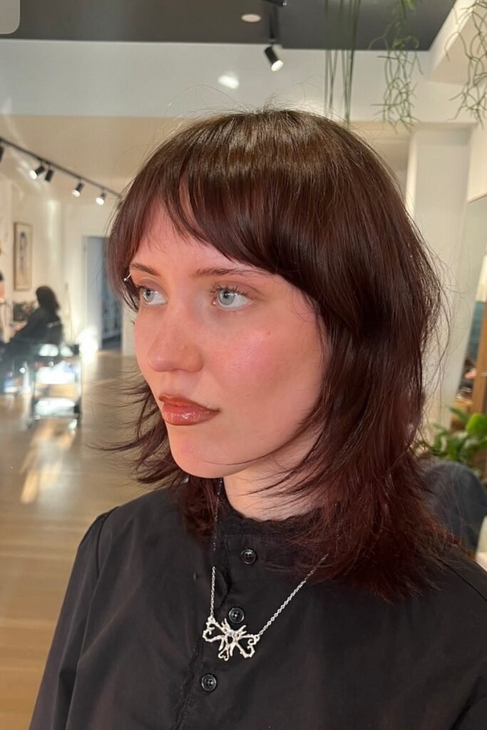 14. Cherry Mahogany Shag with Blunt Bangs