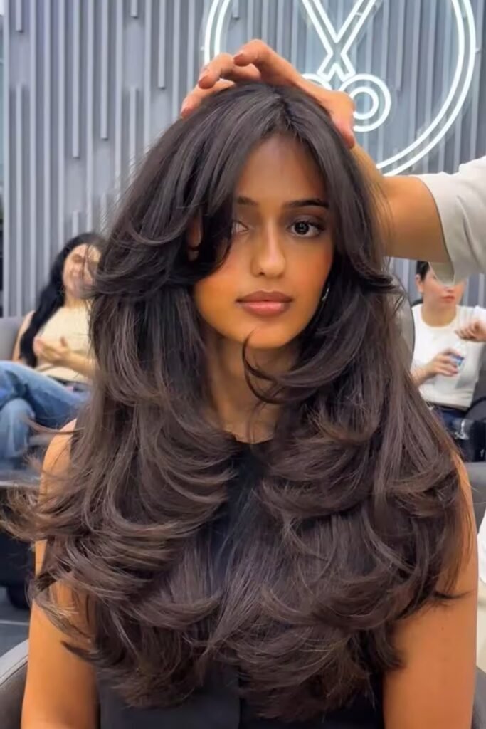 4. (Voluminous Blowout Layers with Curtain Bangs)