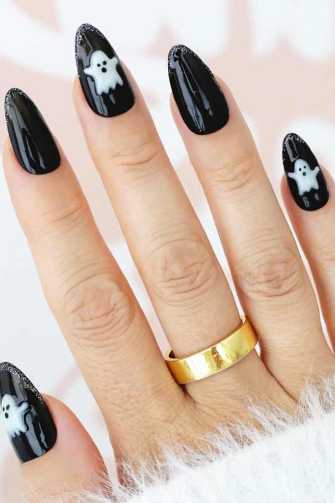 1. Black Almond Nails with Cute Ghosts and Glitter Tips