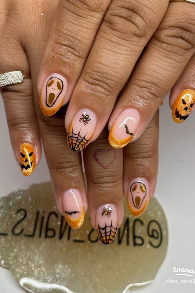 19. Orange Glitter French Tips with Ghost Faces and Bats