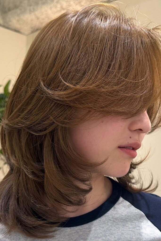 10. (Golden Brown Shaggy Layers with Side Swept Bangs)