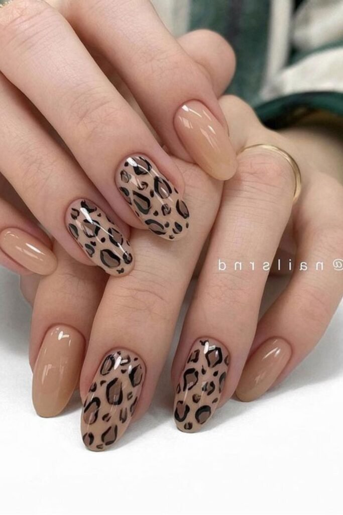 2. Nude Almond Nails with Leopard Accent Nails