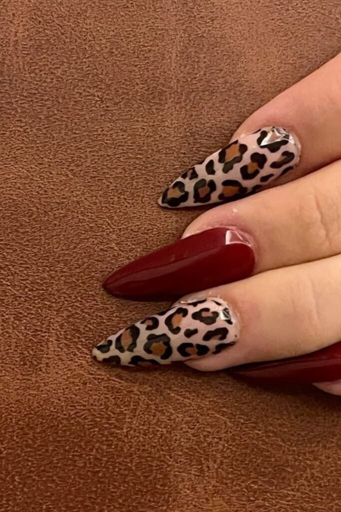 3. Burgundy Stiletto Nails with Leopard Accents