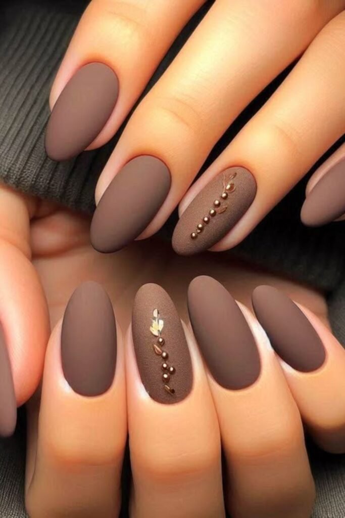 9. Matte Mocha Almond Nails with Gold Beads
