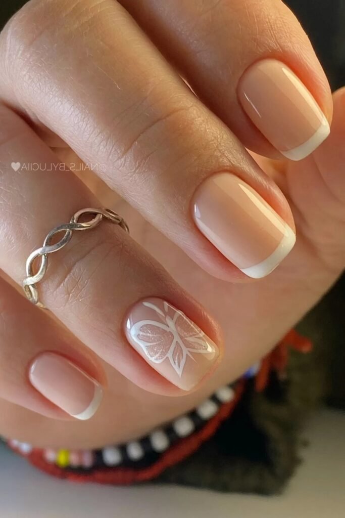 15. White French Tips with Butterfly Accent