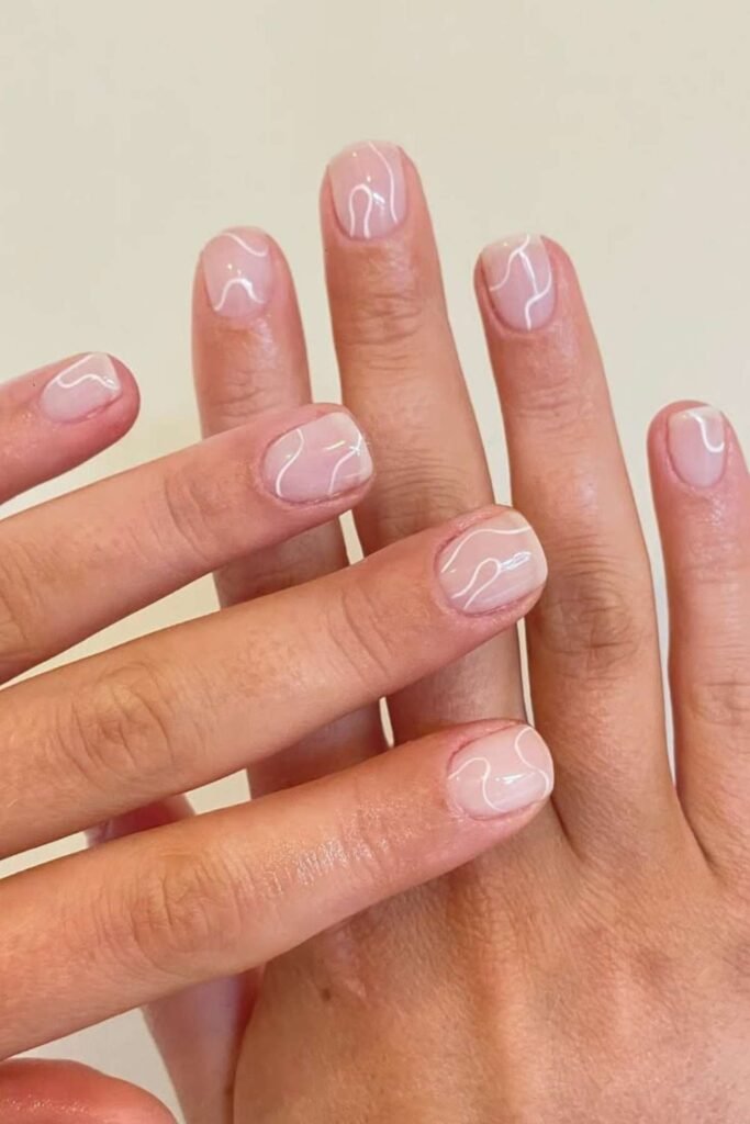 16. Sheer Pink Nails with White Squiggle Lines