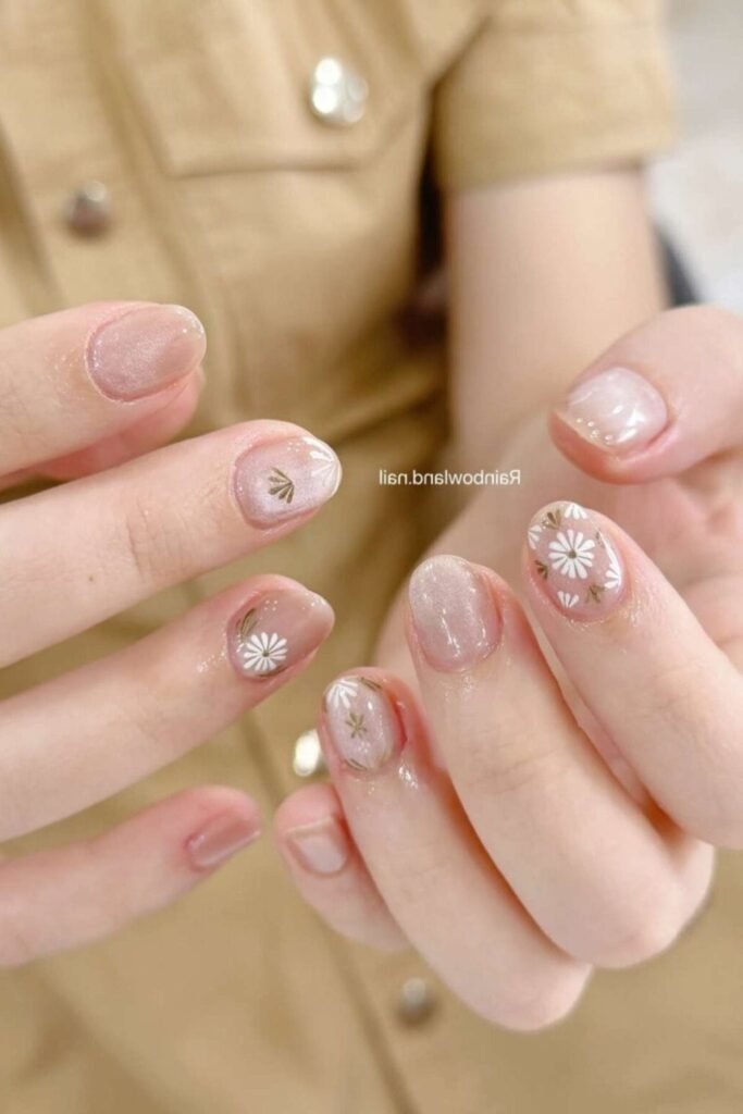 18. Shimmery Nude Nails with Daisy Art