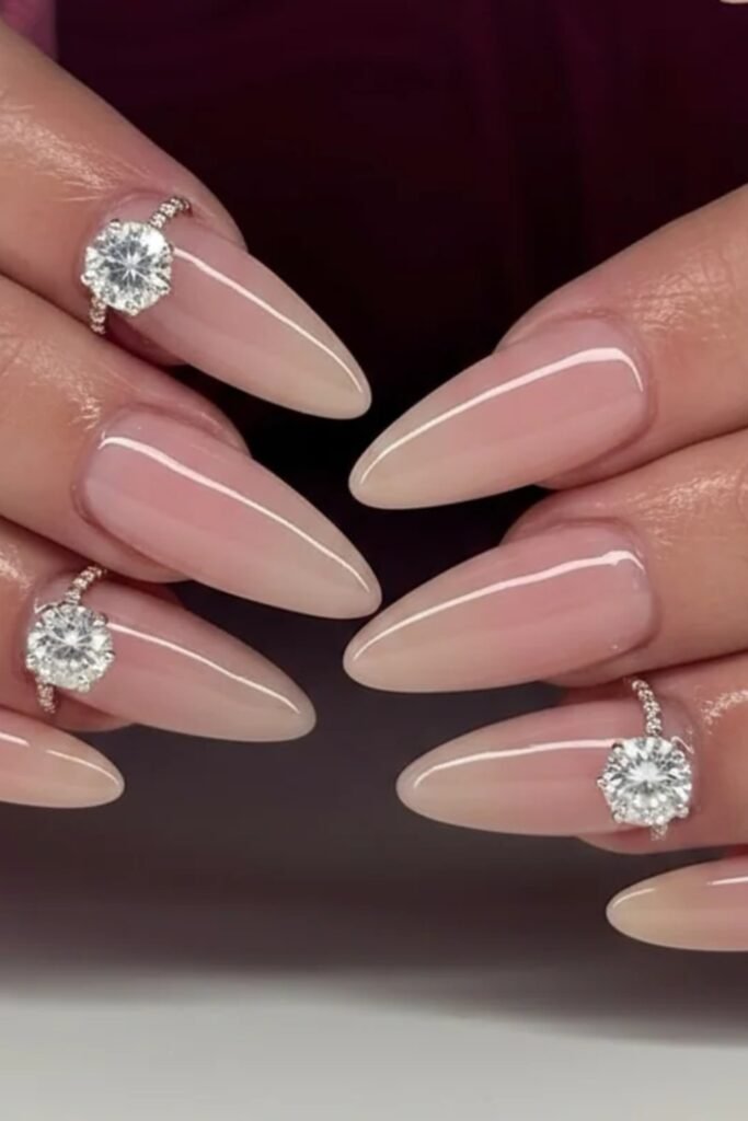 3. Nude Almond Nails with Diamond Ring Charms