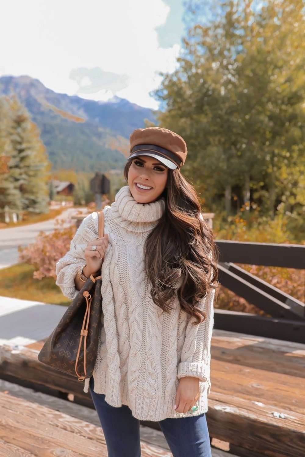 16. Cream Cowl Sweater with a Baker Boy Cap and Jeans