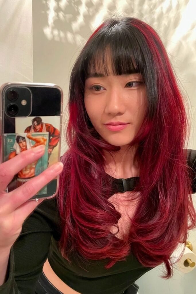 7. Black Bangs with Red Ombre Layers