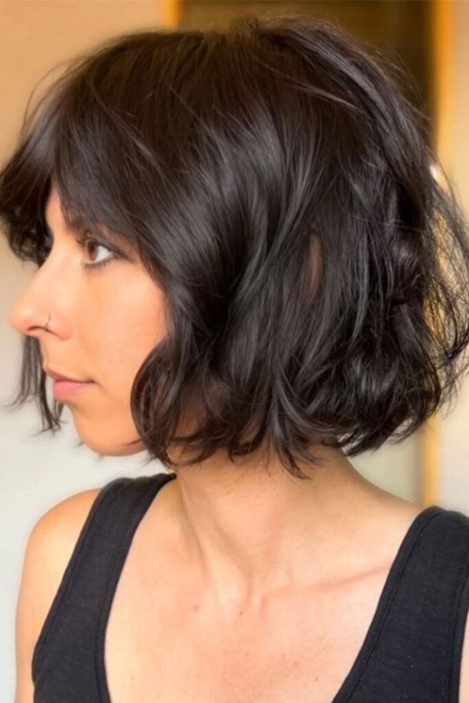 16. Black Wavy Messy Bob with Wispy Side Bangs