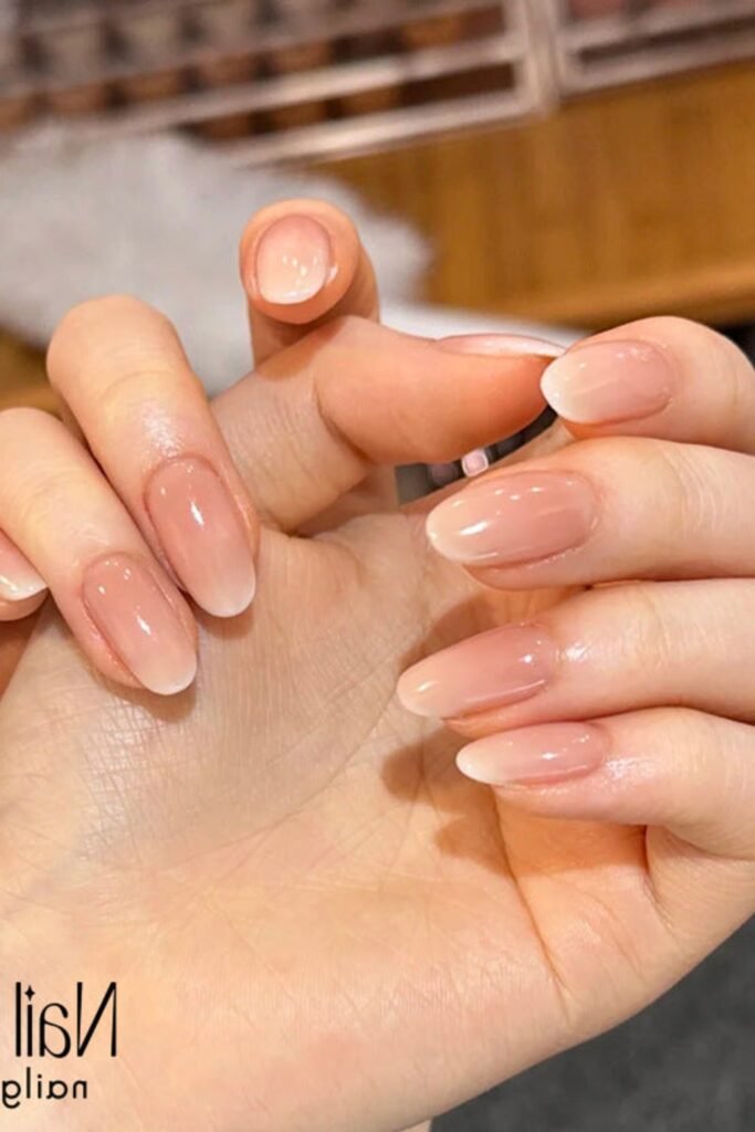14. Peachy Nude Ombre Almond Nails