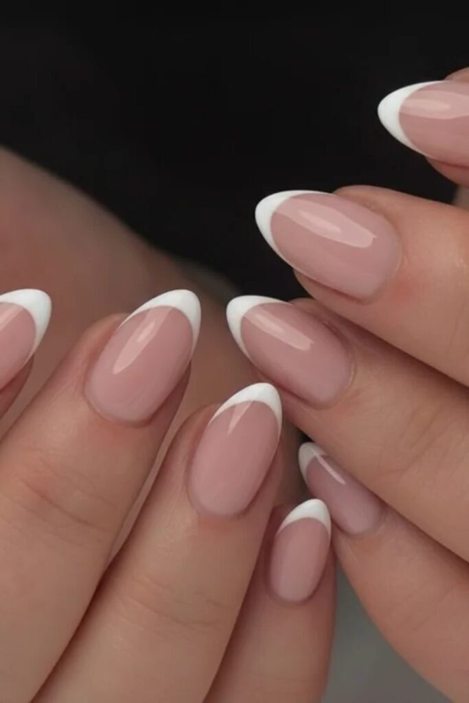 16. Classic White French Tips on Almond Nails