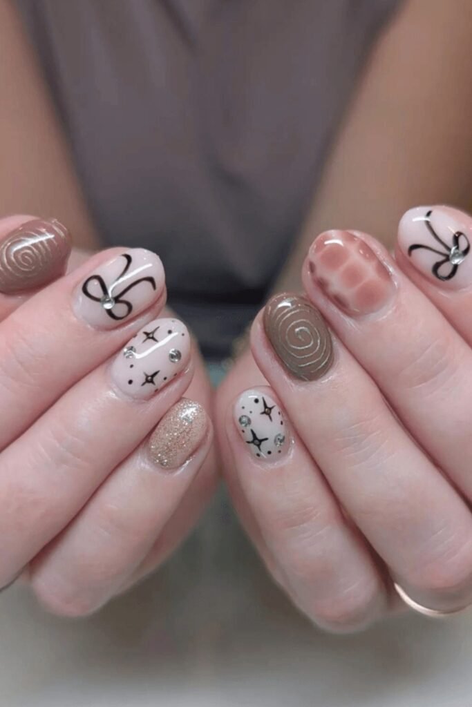 7. Short Brown Nails with Bows, Stars, and Swirls