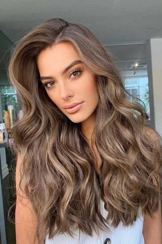 9. Ash Brown Beach Waves with Face-Framing Highlights
