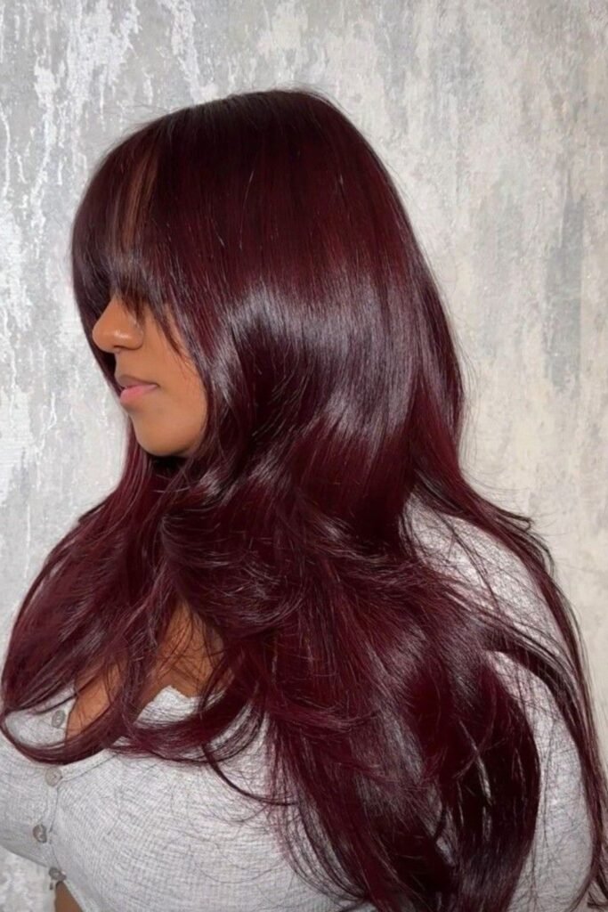 15. (Glossy Oxblood Layers with Wispy Bangs)